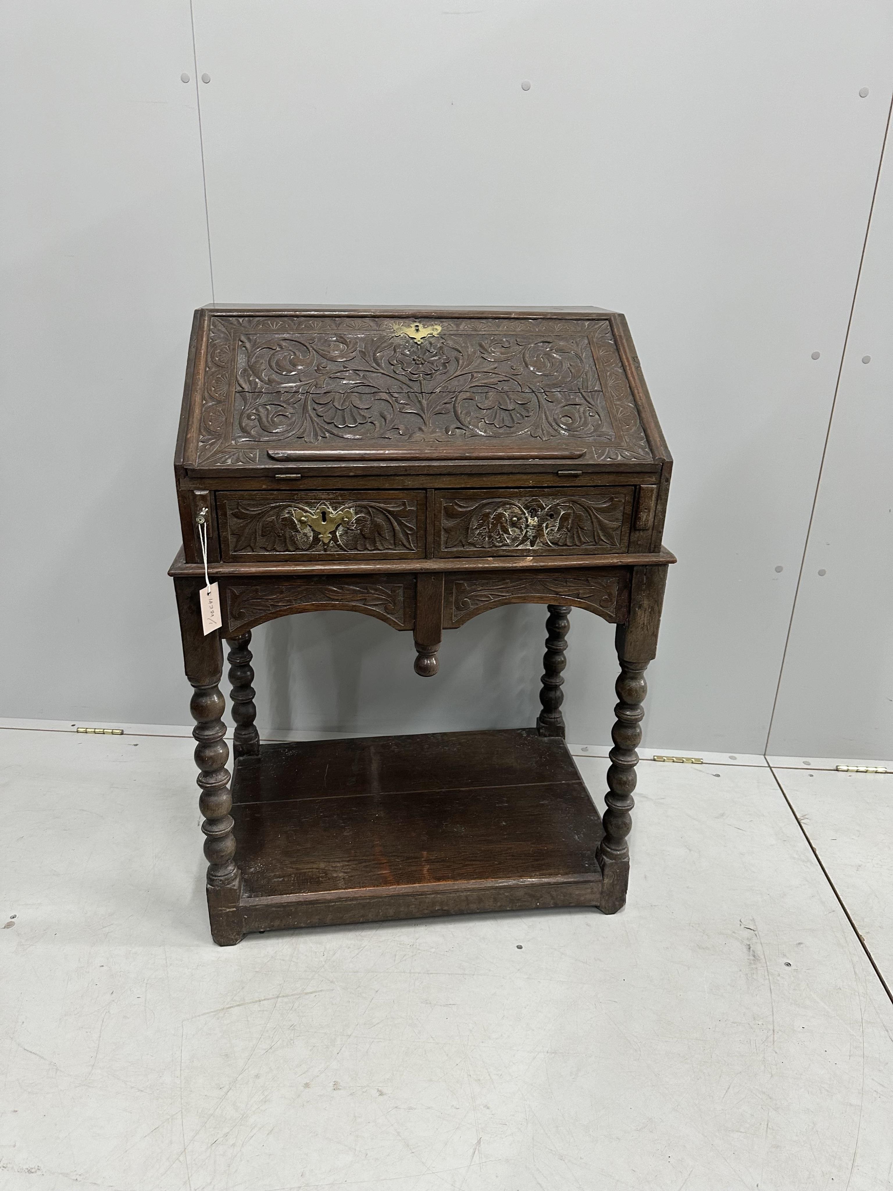 A carved oak bureau, width 68cm, depth 48cm, height 97cm